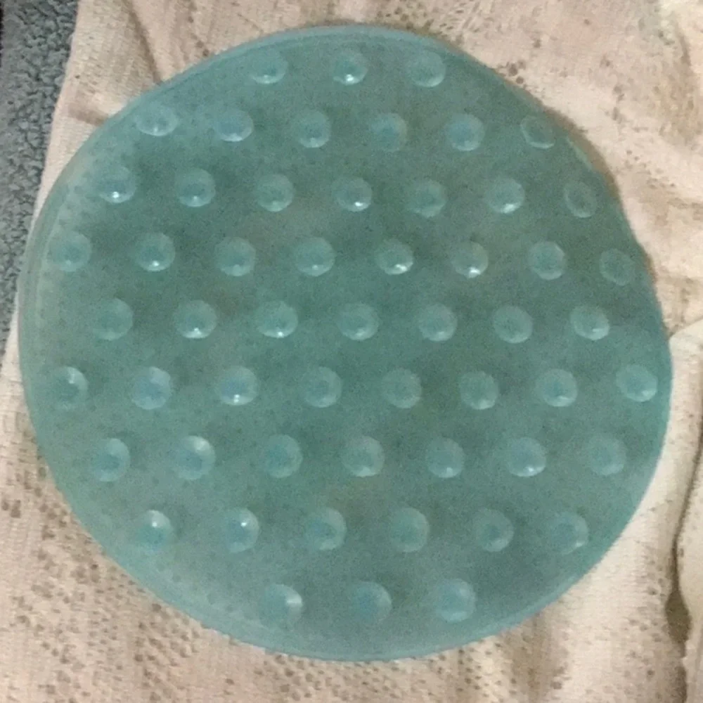 Aqua blue small round shower mat.